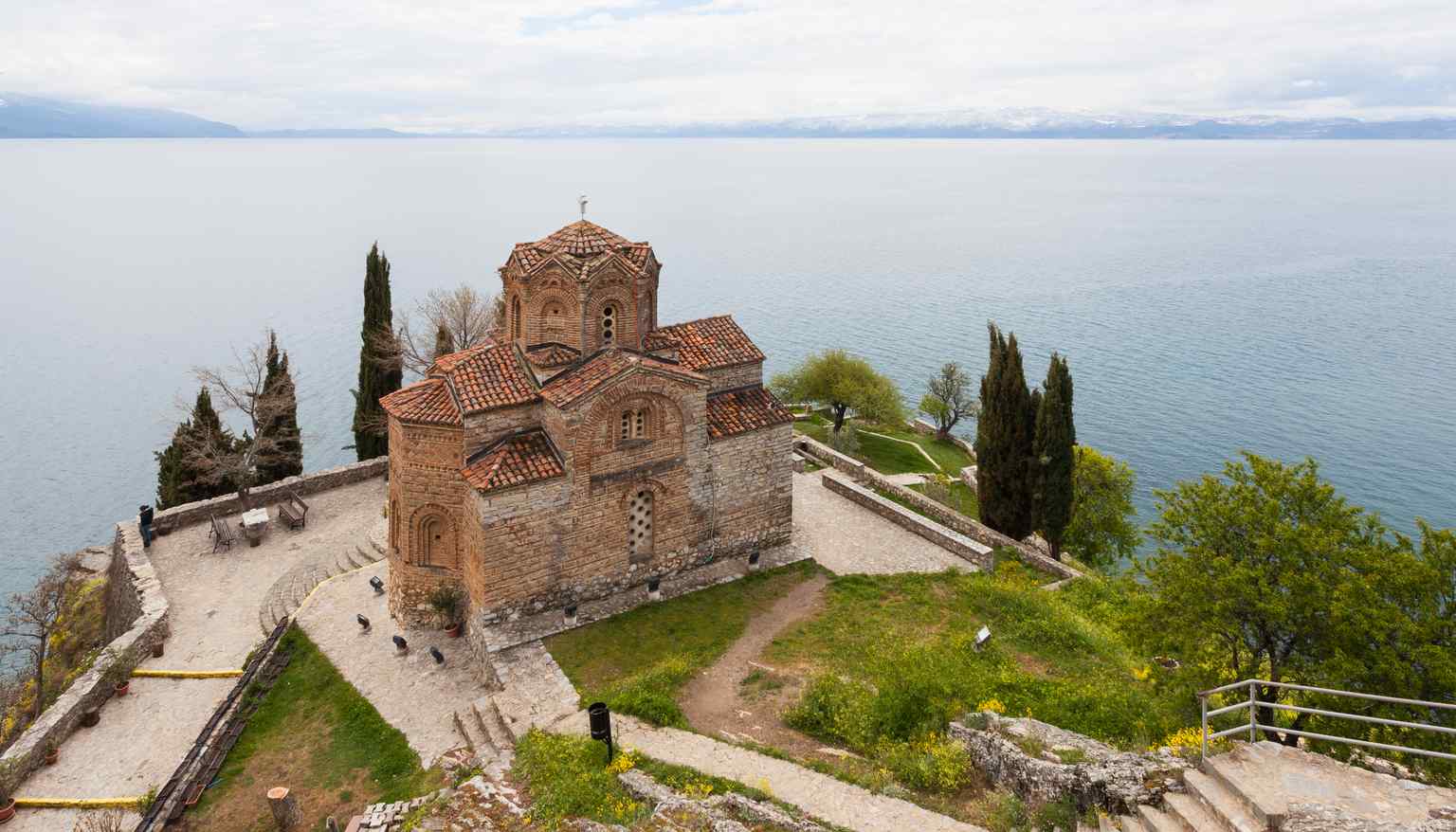 Observe the church's unique zigzag roofline on the dome, an architectural feature reminiscent of medieval Armenian churches that suggests Eastern influence in its design.