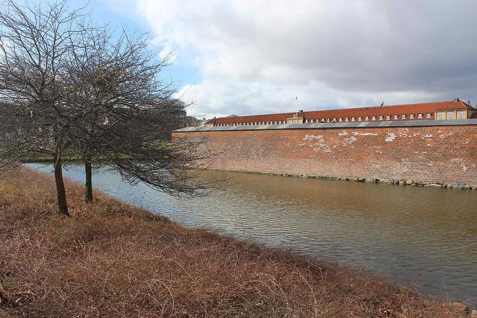 The Royal Life Guards barracks stand adjacent to Rosenborg Castle, fulfilling their duty to guard the historic royal site, just as they have for centuries.