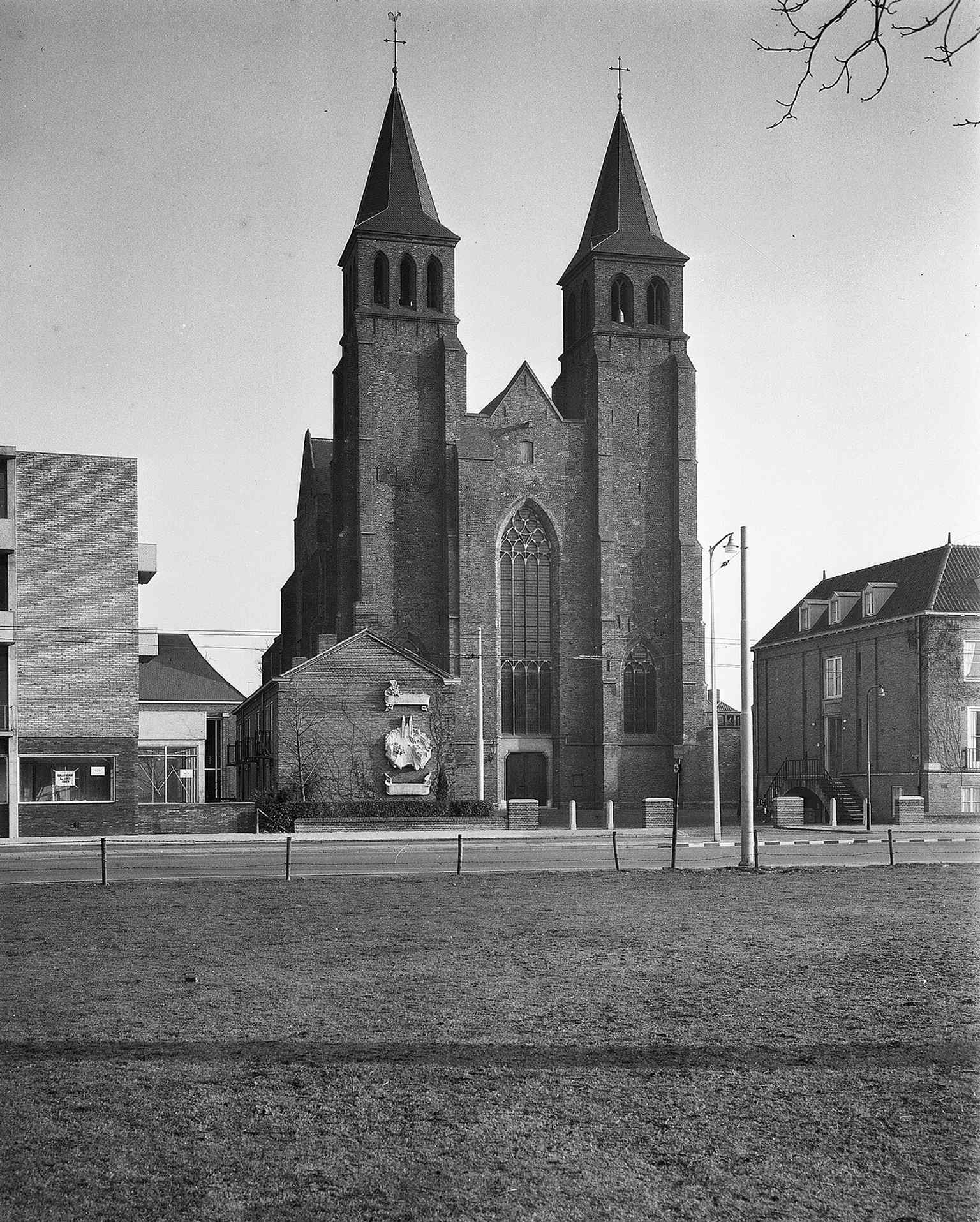 The church from the northwest, emphasizing the massive stone volume and the historic dual-tower silhouette seen from another angle.
