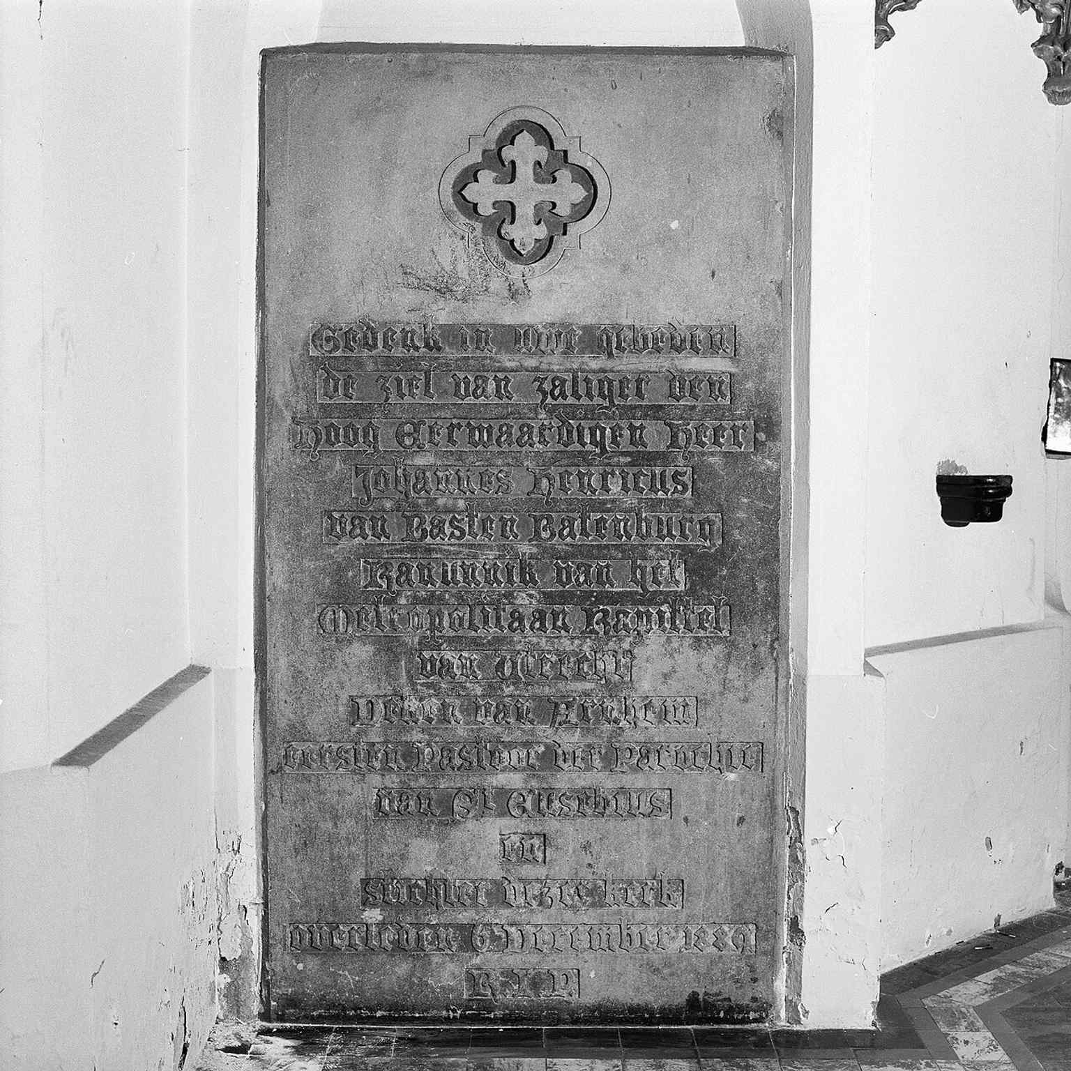 A memorial stone in the chapel beside the tower, linking the building to its later devotional and historic layers.