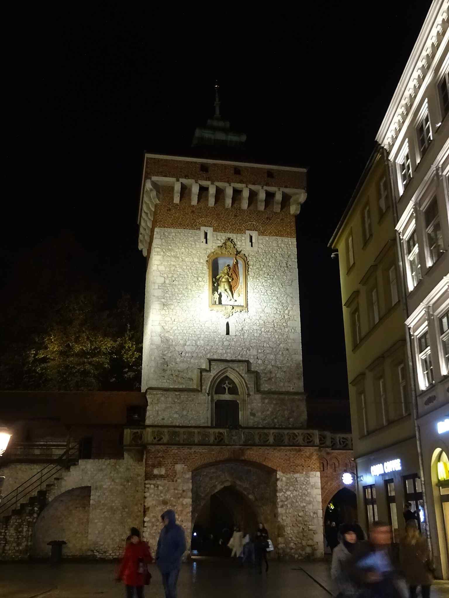 The south-side relief of Saint Florian extinguishing a burning building, echoing the gate’s role as a protector not only against armies but also against fire.