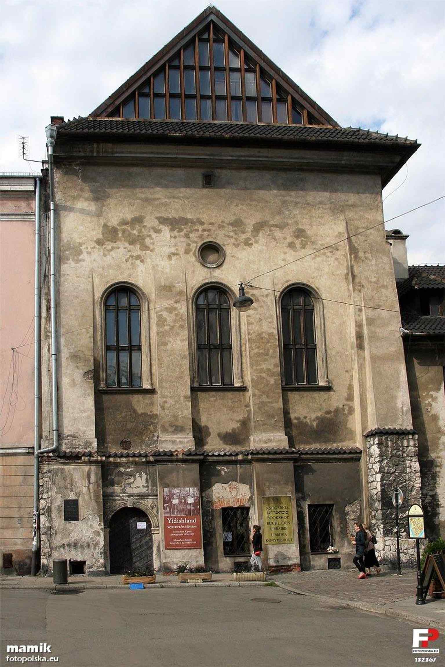 View from Wąska Street that emphasizes the synagogue’s urban setting and its elevated, defensive-looking massing.