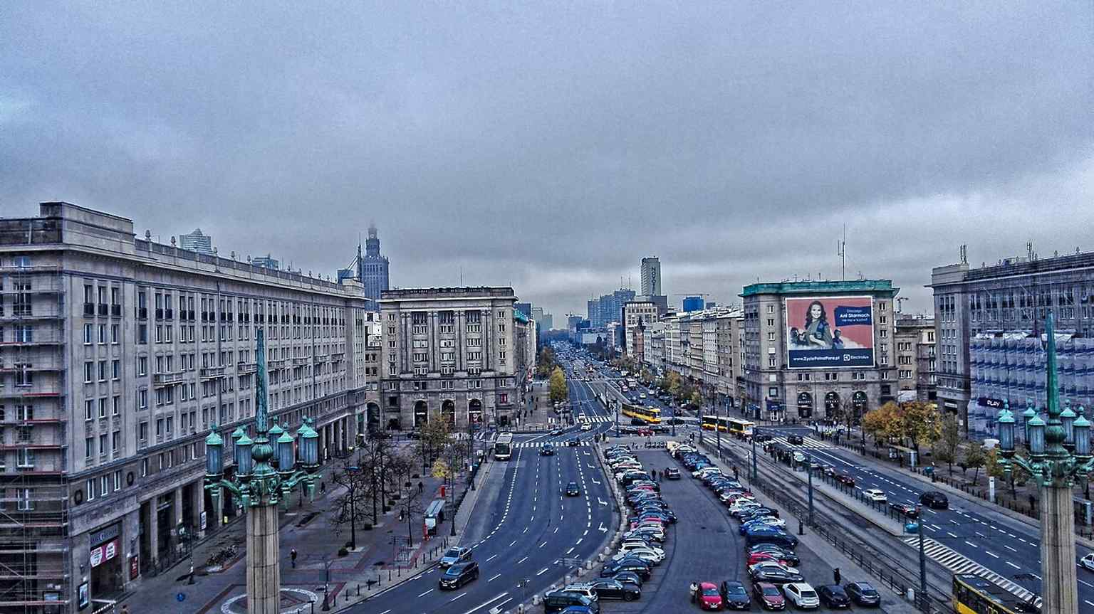 The square seen from Hotel MDM in 2016, emphasizing the grand socialist-realist façades and the long perspective toward the center.