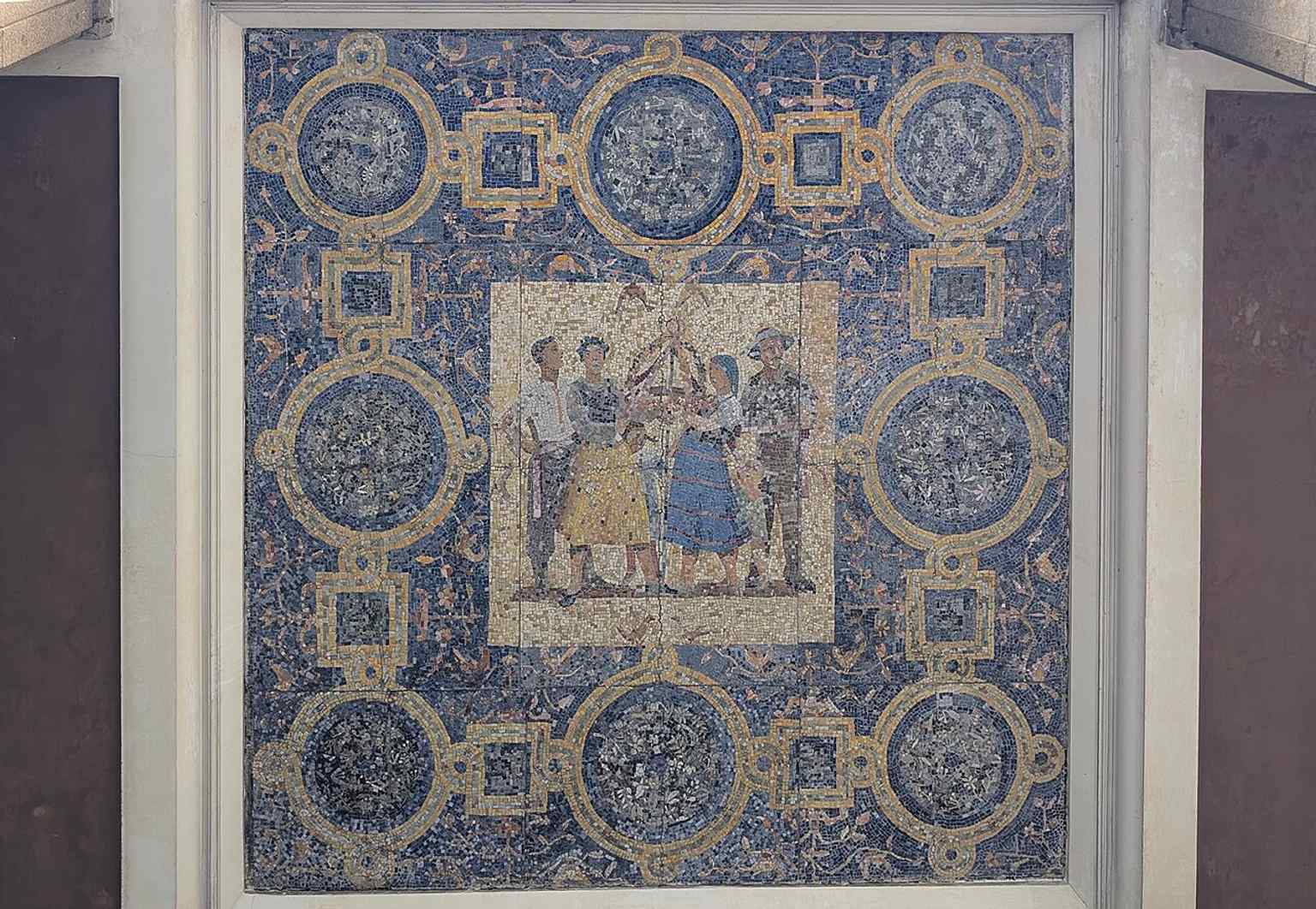 A ceiling mosaic in one of the arcades, echoing the decorative interiors and public-art layer built into the MDM complex.