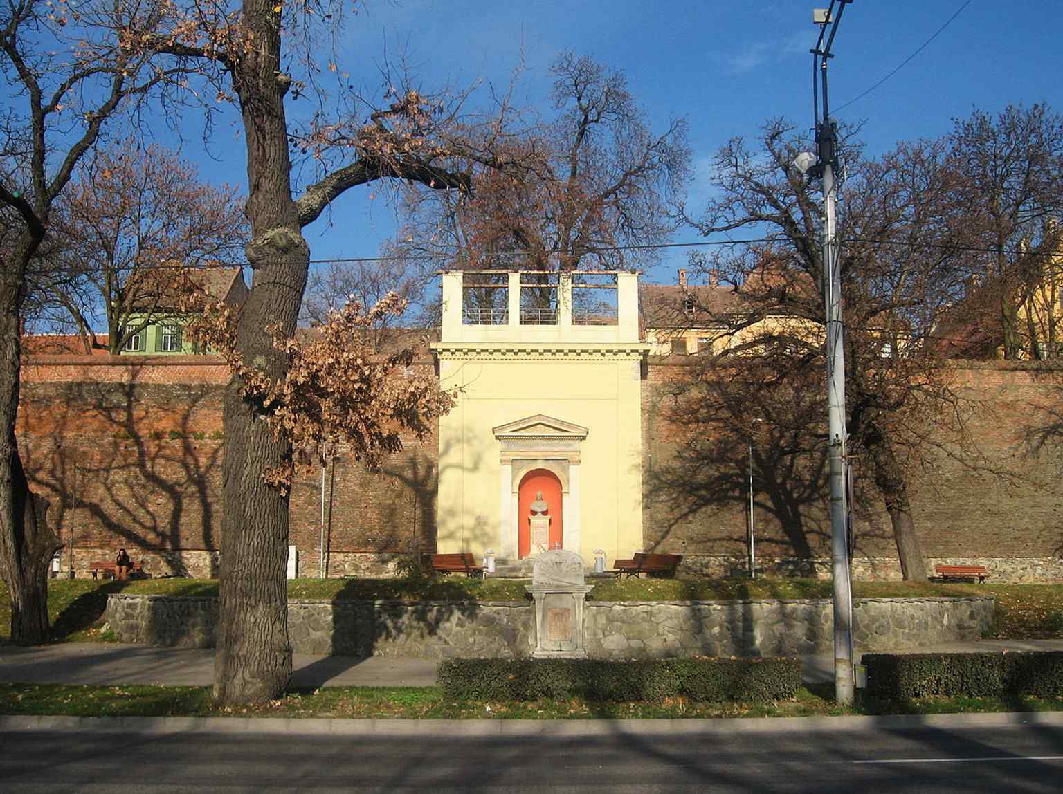 The monument is seen from Corneliu Coposu Boulevard, the site of the former "Promenade of Invalids" established by Colonel Johann von Vecsey.