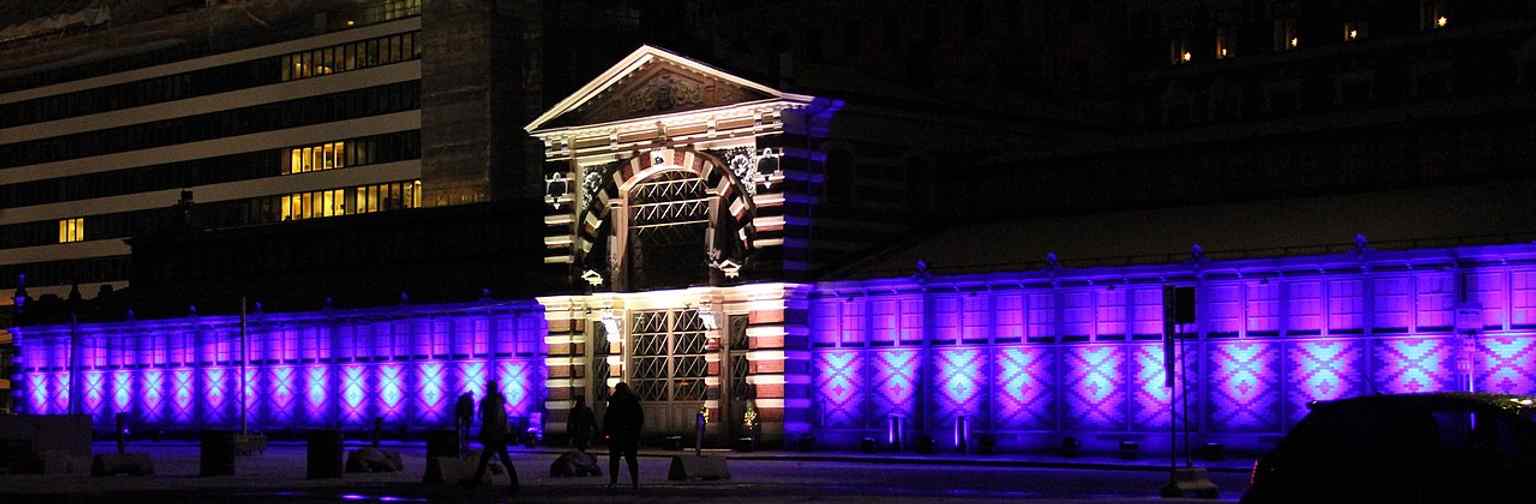 The hall lit in blue and white for Finland’s centenary, showing how this 19th-century building still serves as a living city landmark.