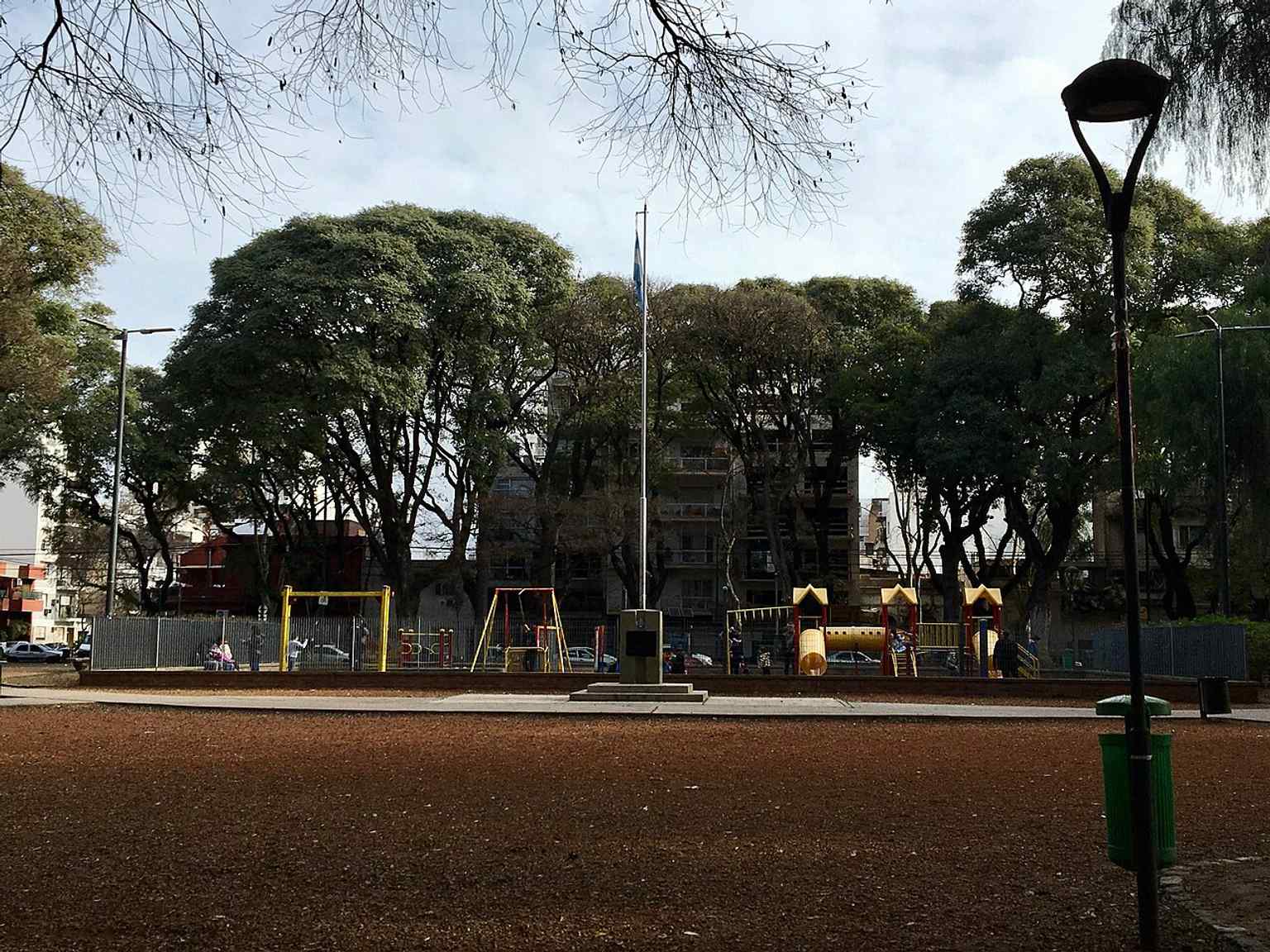 The central mast shown here commemorates the neighborhood's military heritage, with a new plaque installed in 2017 to honor fallen soldiers and mark the 35th anniversary of the Malvinas War.