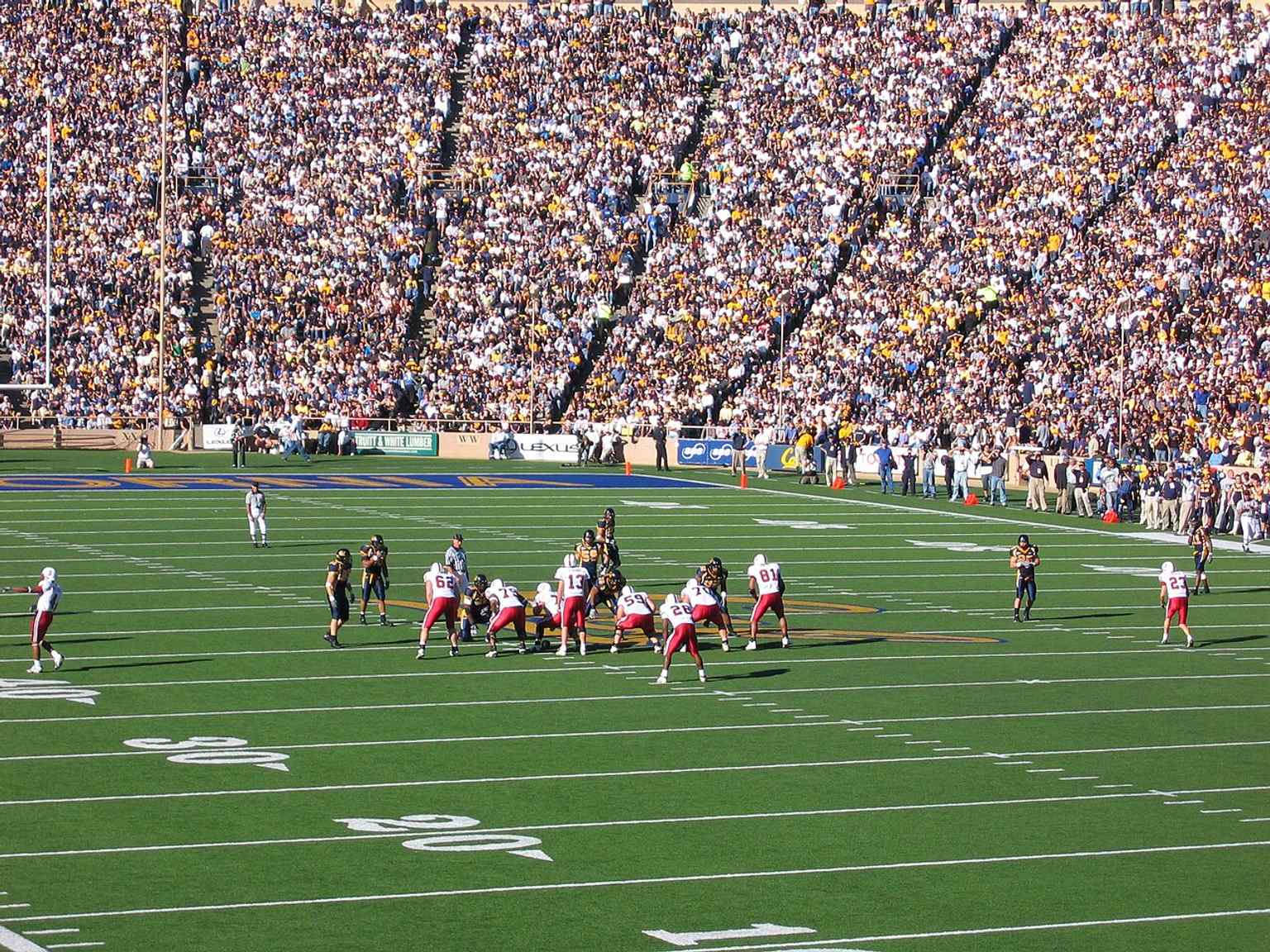 A Big Game action scene from 2004 connects the stadium to its most famous rivalry and the packed-game atmosphere it is known for.