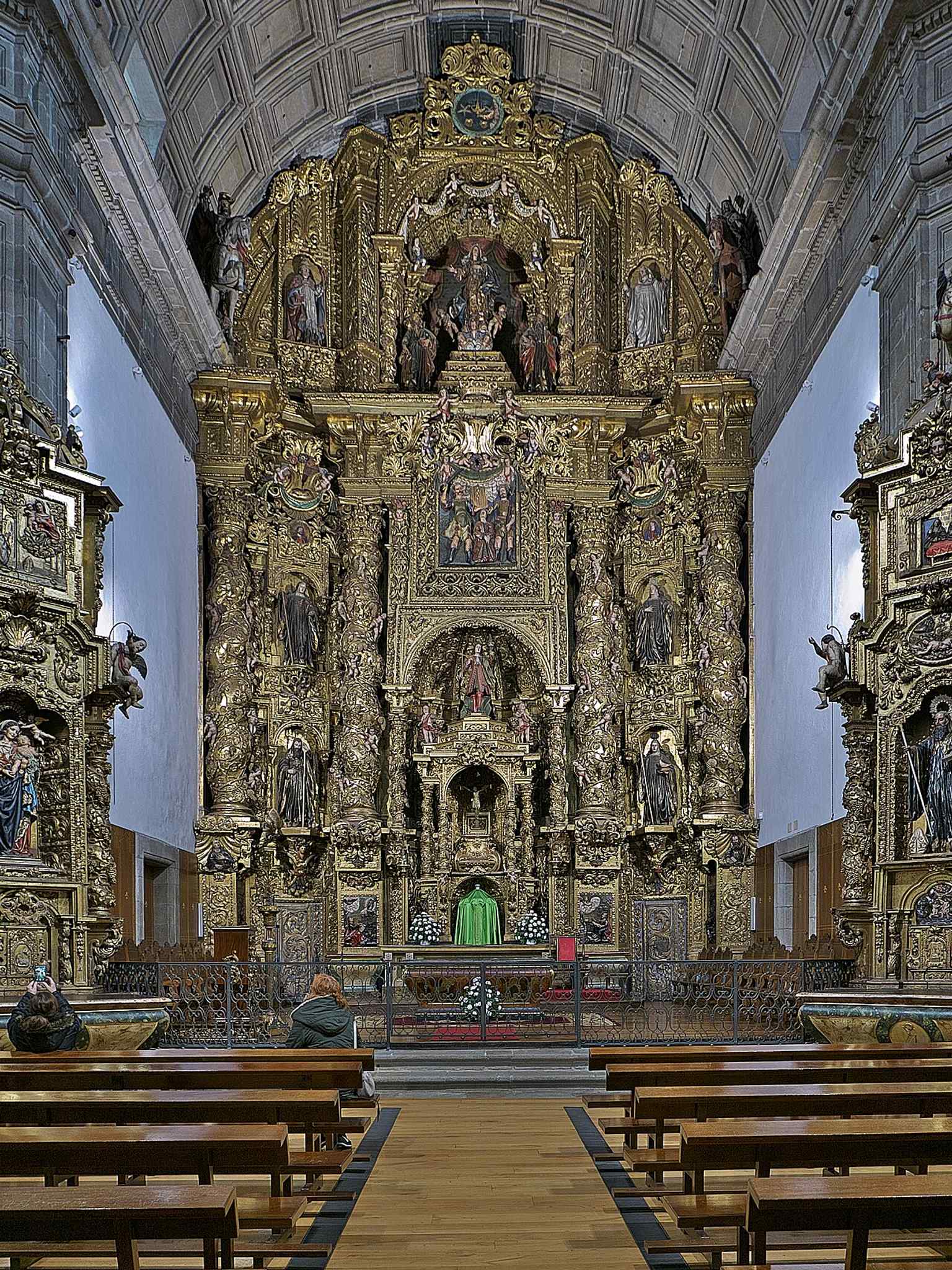 This magnificent main altarpiece, crafted by Francisco de Castro Canseco in 1714, is a highlight of the monastery's lavish 18th-century Baroque reforms.