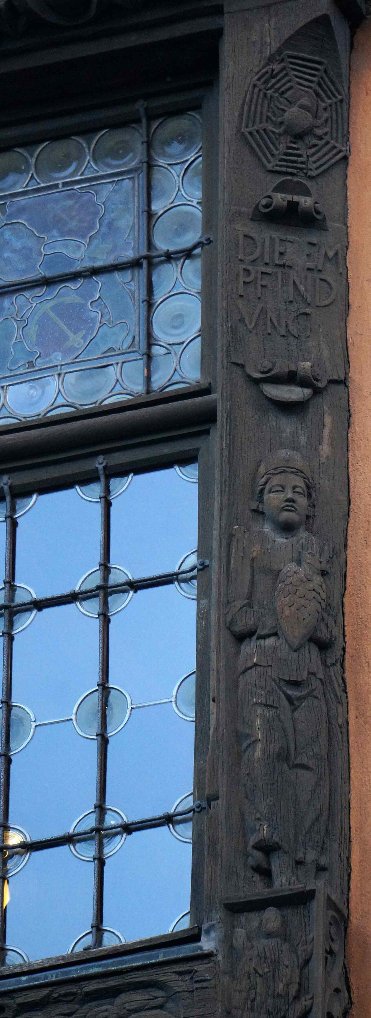 A vivid close-up of the carved exterior artwork, showing how the house’s decorations became so elaborate after the 1589 rebuilding.
