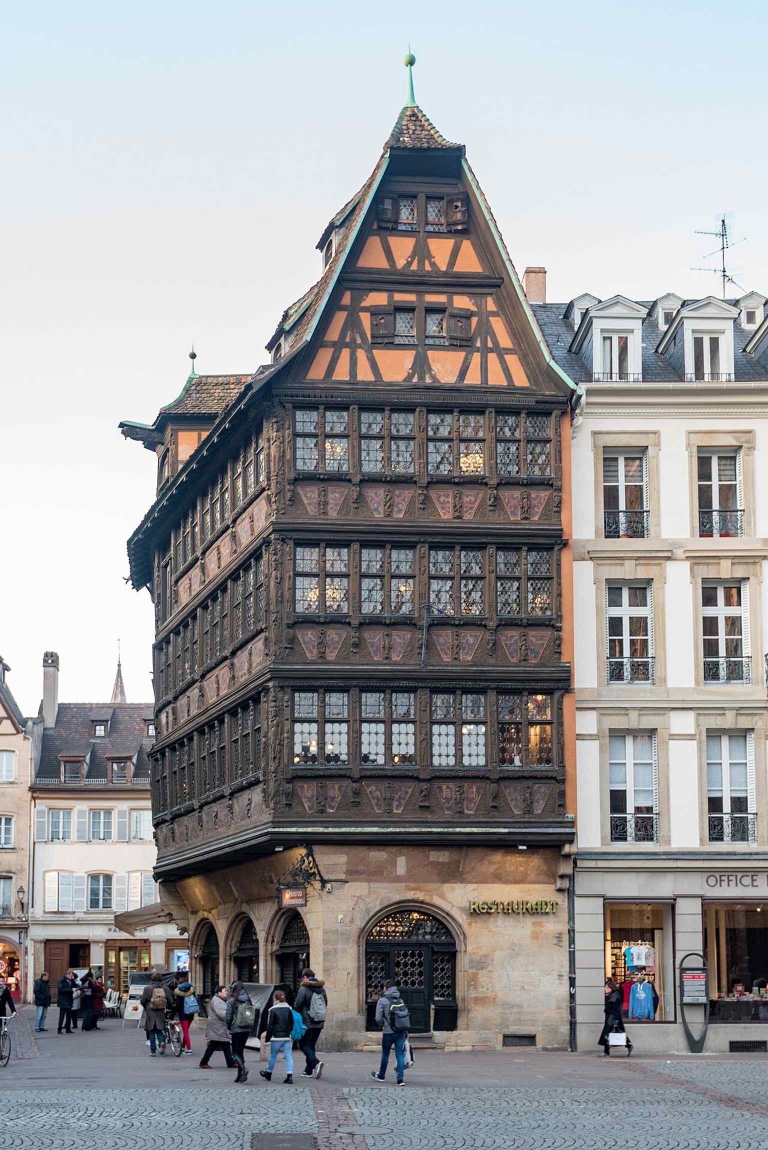 Another modern exterior angle of the house, helping show its dramatic height and layered timber-and-stone structure.