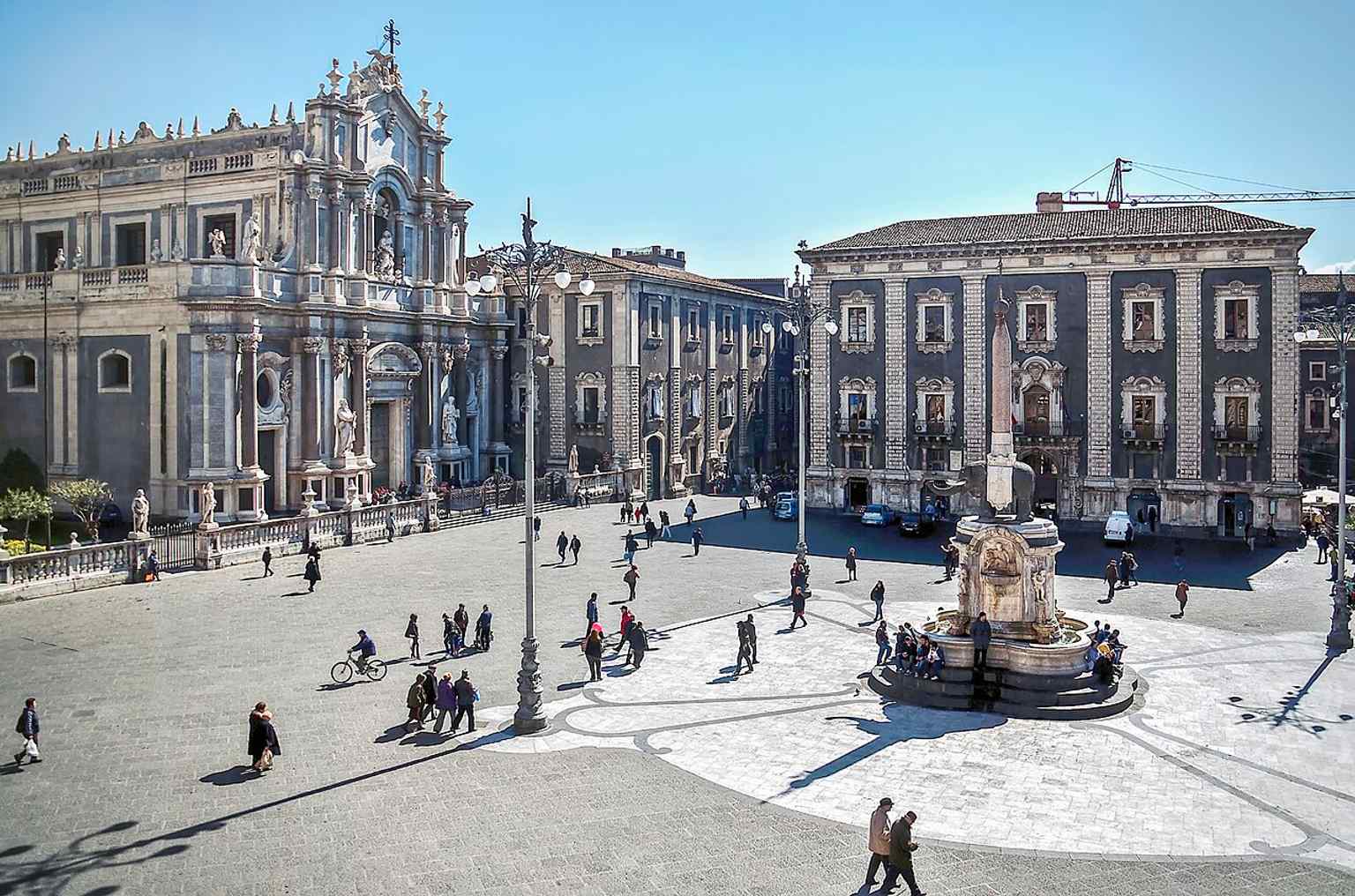 Piazza Duomo, the civic and religious heart of the old town, where the cathedral, city hall and Porta Uzeda meet in one monumental space.