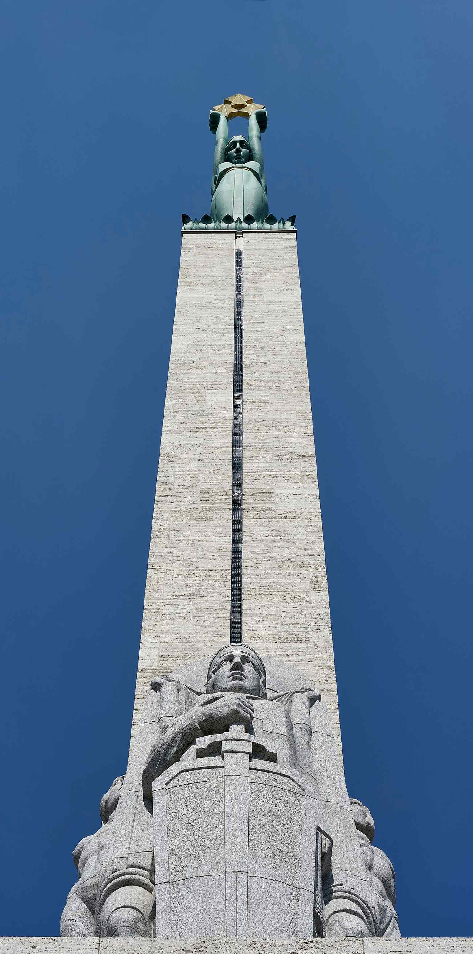 Full frontal view of the Freedom Monument, the 42-meter symbol of Latvian independence and a focal point for national ceremonies in central Riga.