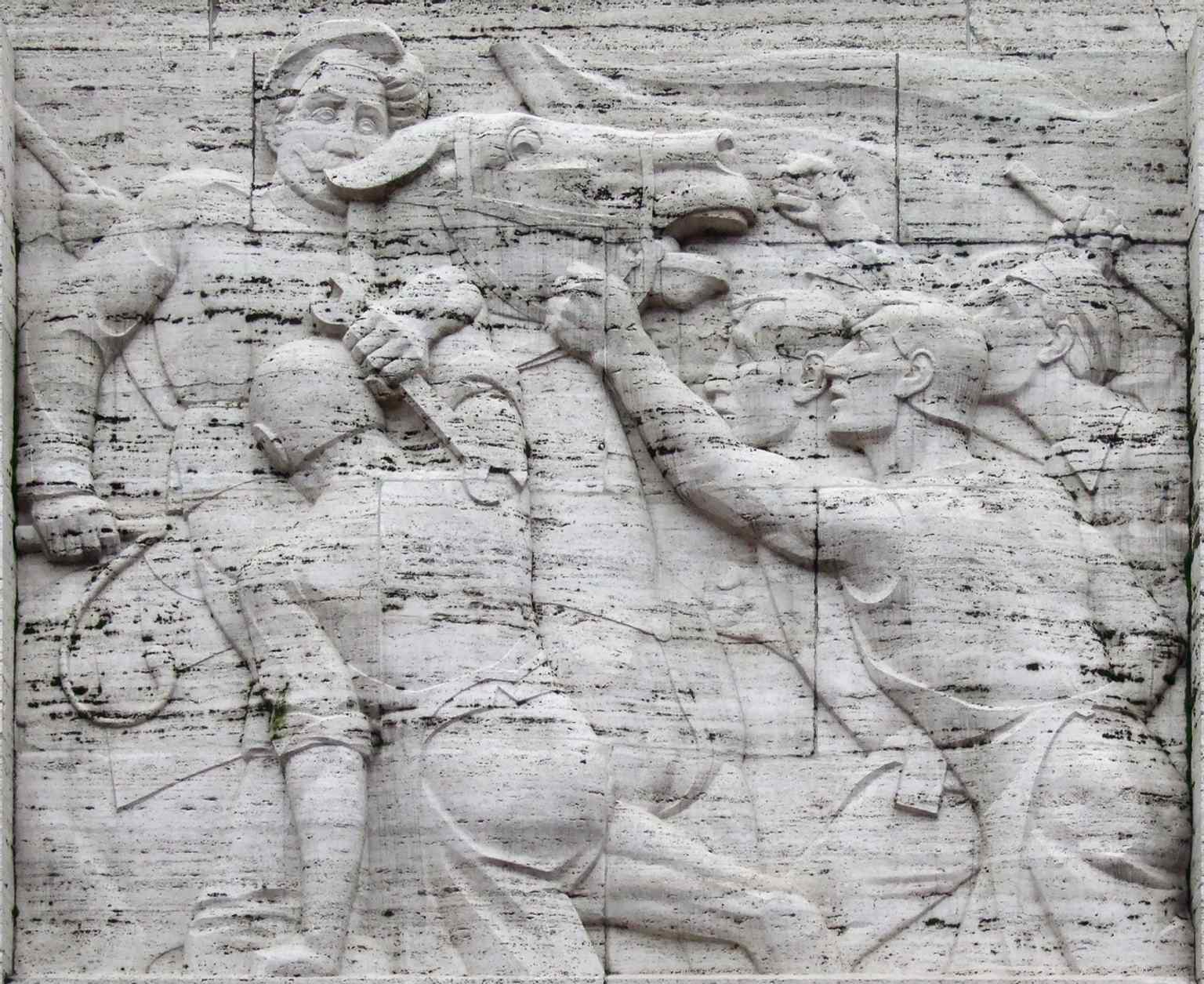 The ‘1905’ relief connects the monument to Latvia’s earlier revolutionary history and long fight for self-determination.