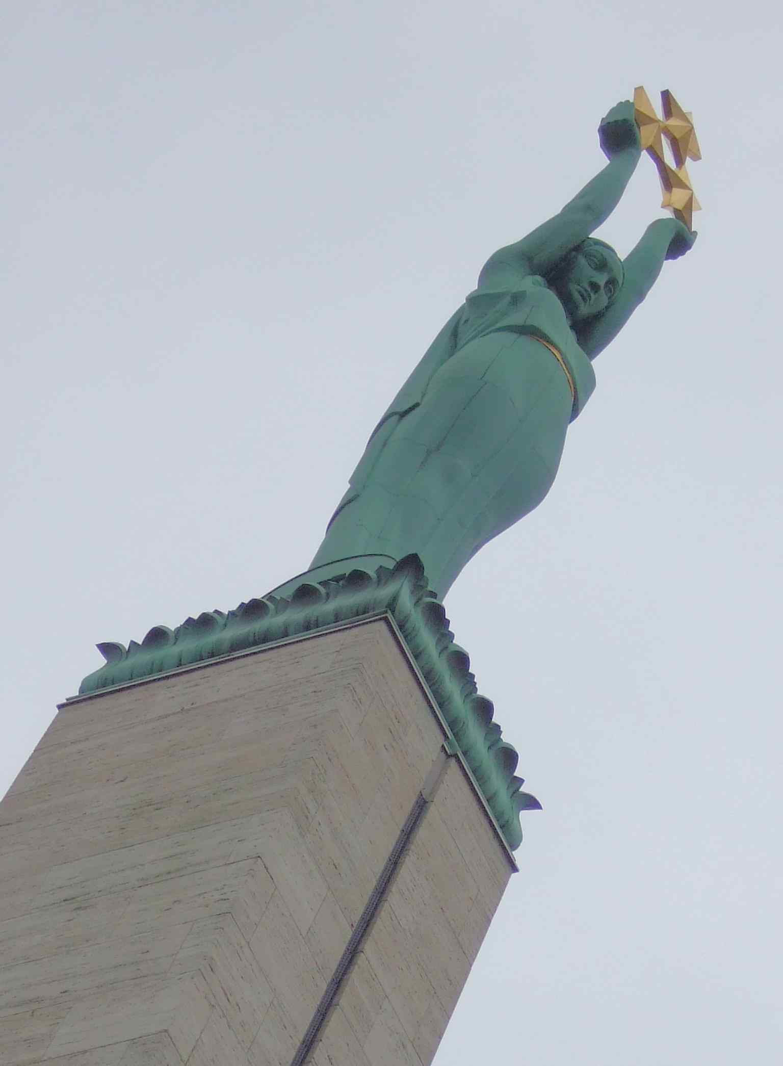 The copper figure of Liberty, affectionately called Milda, holding the three gilded stars that symbolize Latvia’s historic regions.
