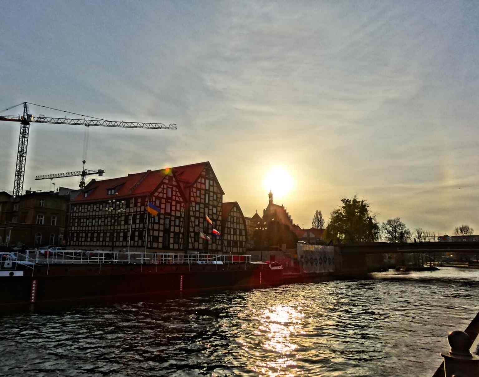 A classic riverfront view of the cathedral over the Brda, matching the source’s emphasis on its place in the city’s waterfront scenery.
