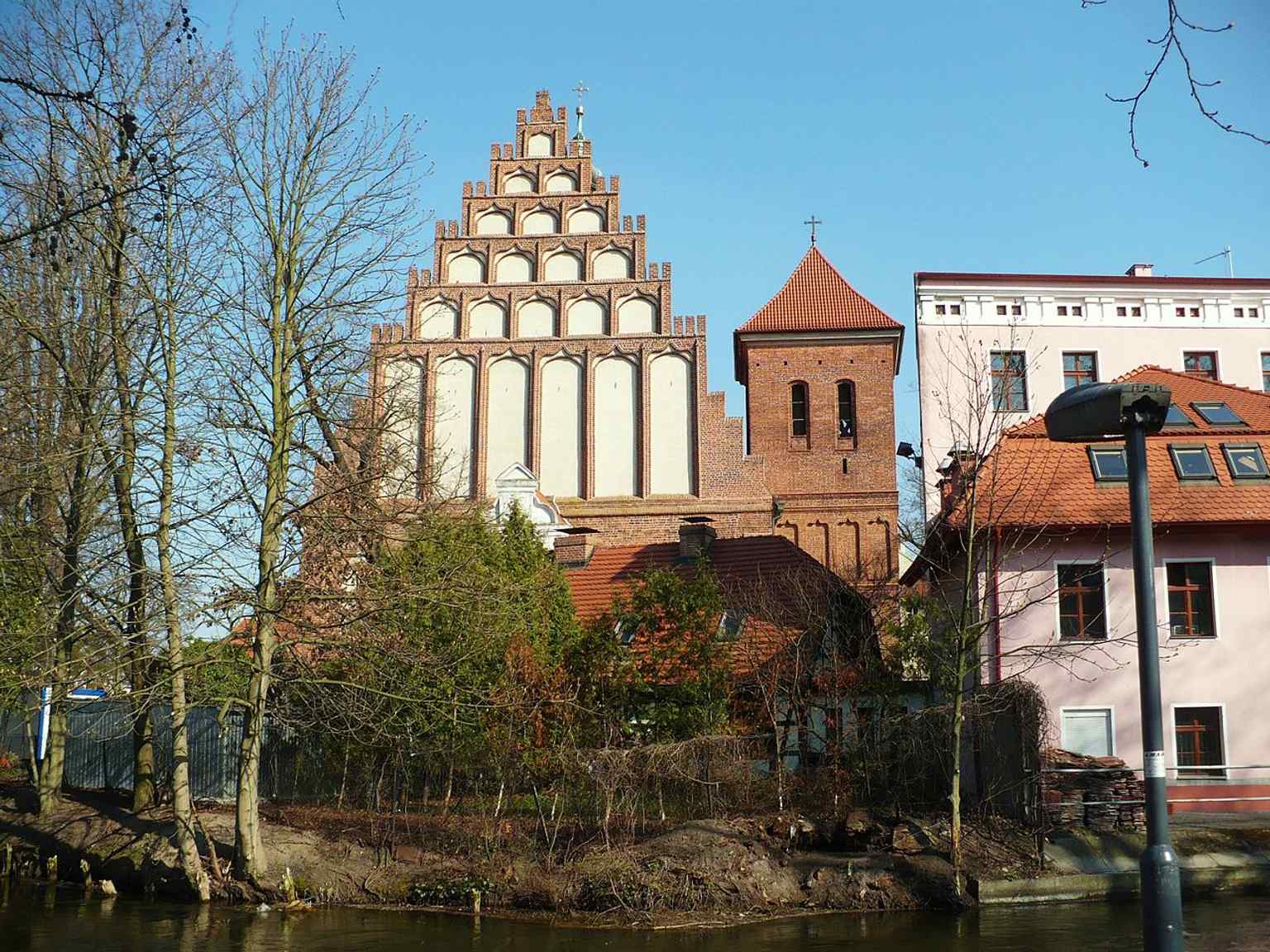 The stepped west gable in close view, highlighting the brick Gothic ornament that defines the building’s medieval character.