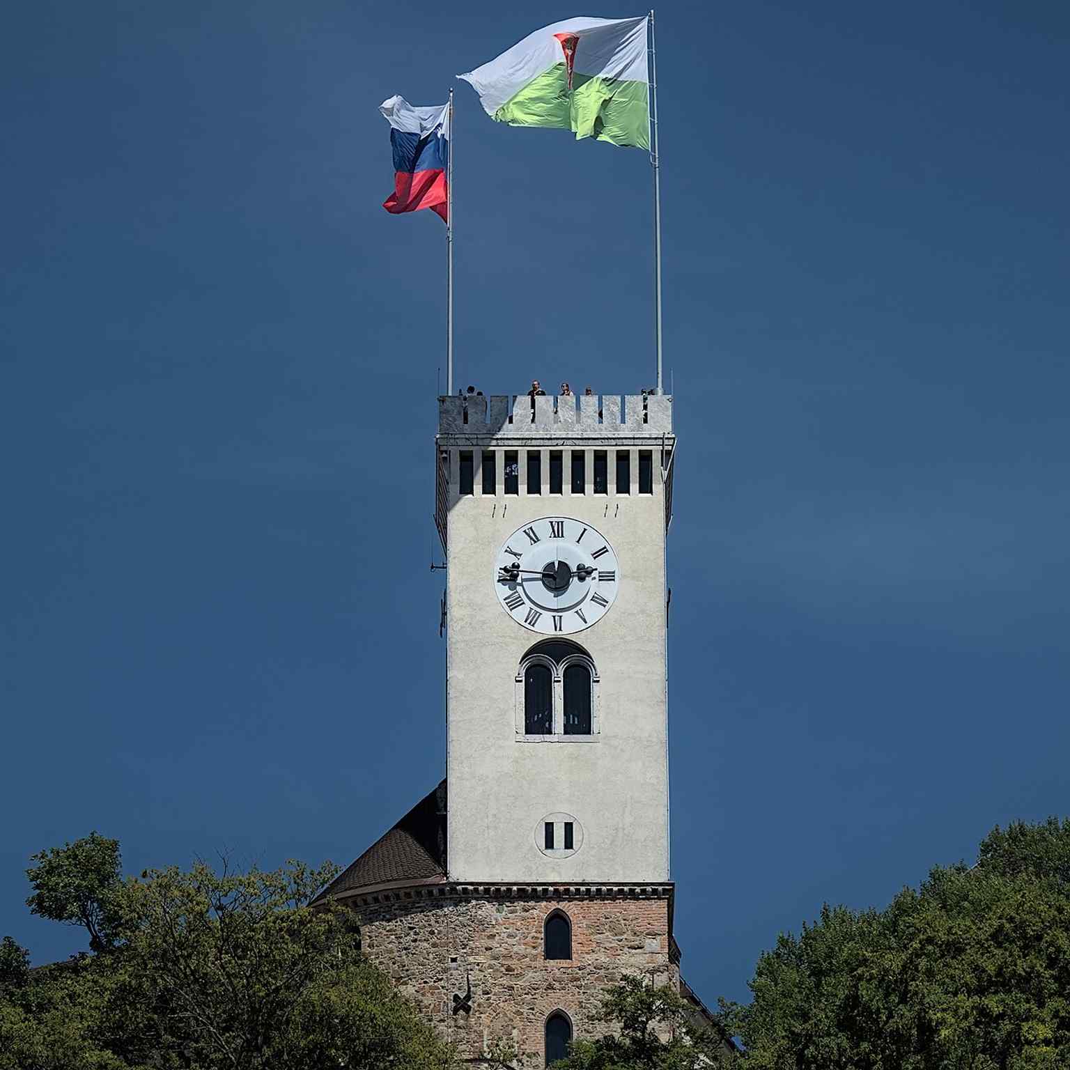 The Viewing Tower of Ljubljana Castle, rebuilt in masonry in the 1840s, proudly flies the national and city flags, representing its continued role as a civic and historical symbol.