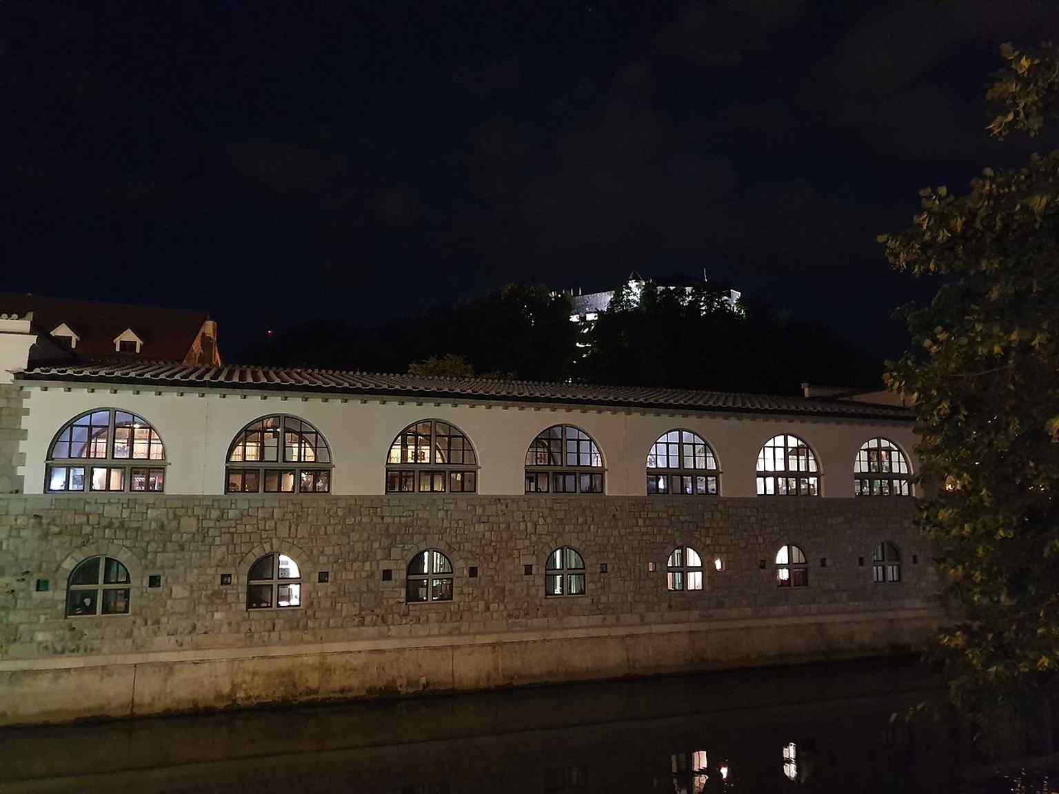 Ljubljana Castle illuminated at night, highlighting its modern role as a major cultural venue, hosting weddings and events after extensive renovations began in the 1970s.