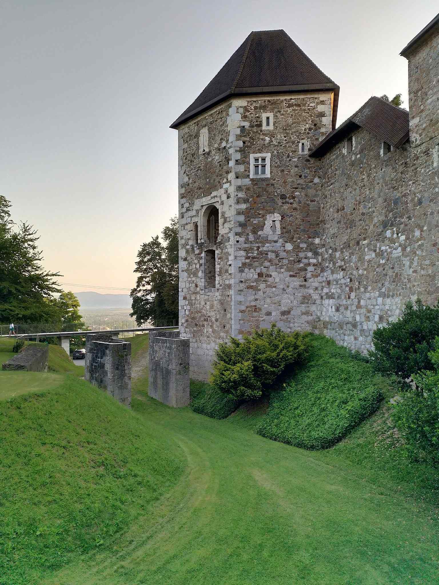 The castle's entrance bridge, restored to its medieval appearance, features a sculpture of the legendary dragon, a symbol of Ljubljana that evolved from a terrifying monster to a guardian.