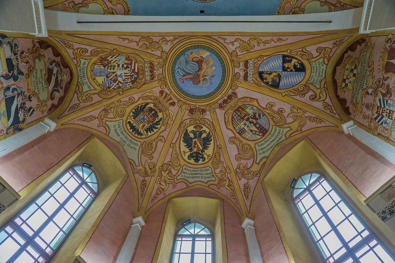 The exterior of the Castle Chapel of St. George, consecrated in 1489, is connected to a local legend crediting Saint George with defeating the dragon, a Christianized version of the city's ancient myth.