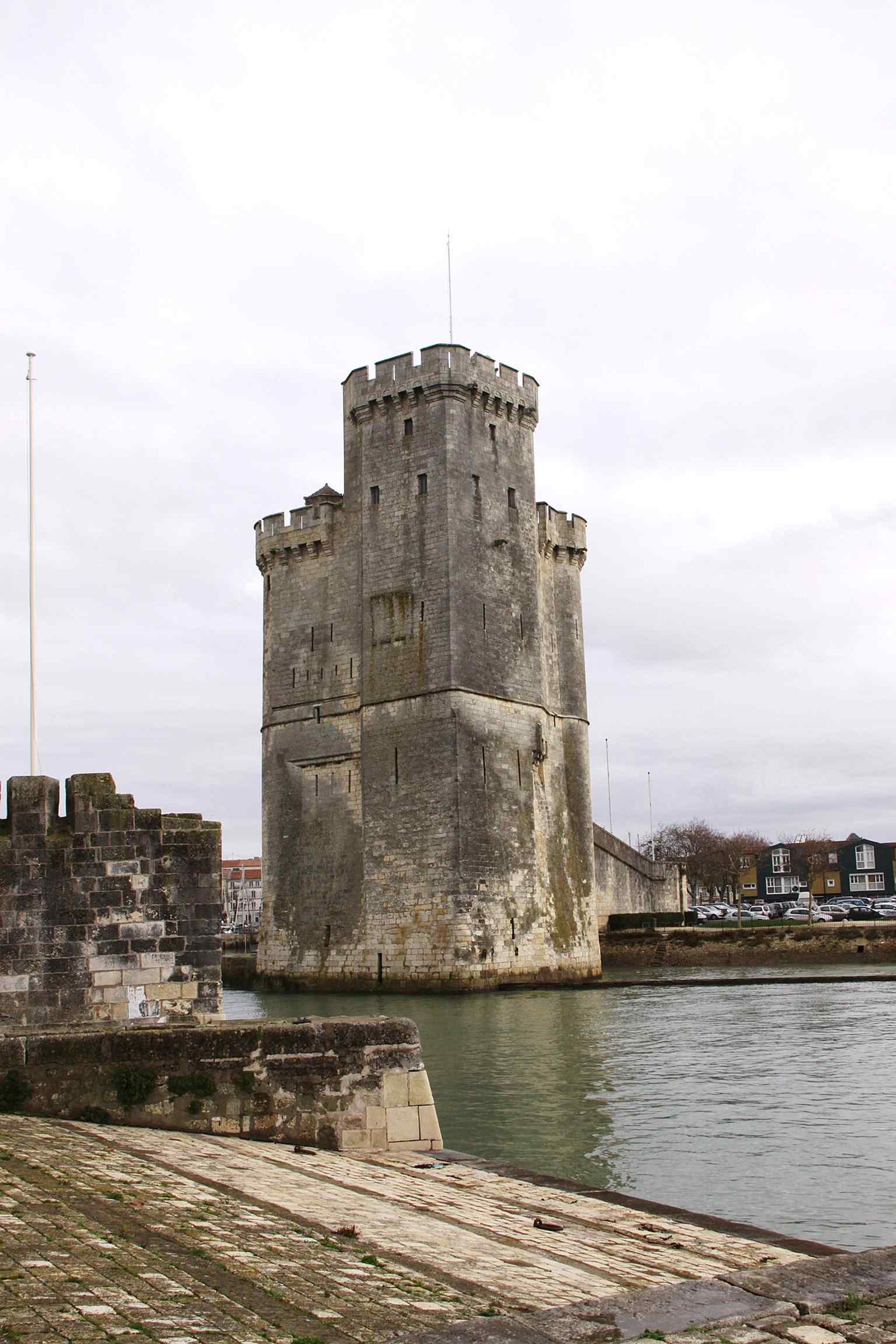 A strong frontal view of Saint Nicholas Tower from the harbor approach, showing the monument standing at the entrance to La Rochelle’s Old Port.