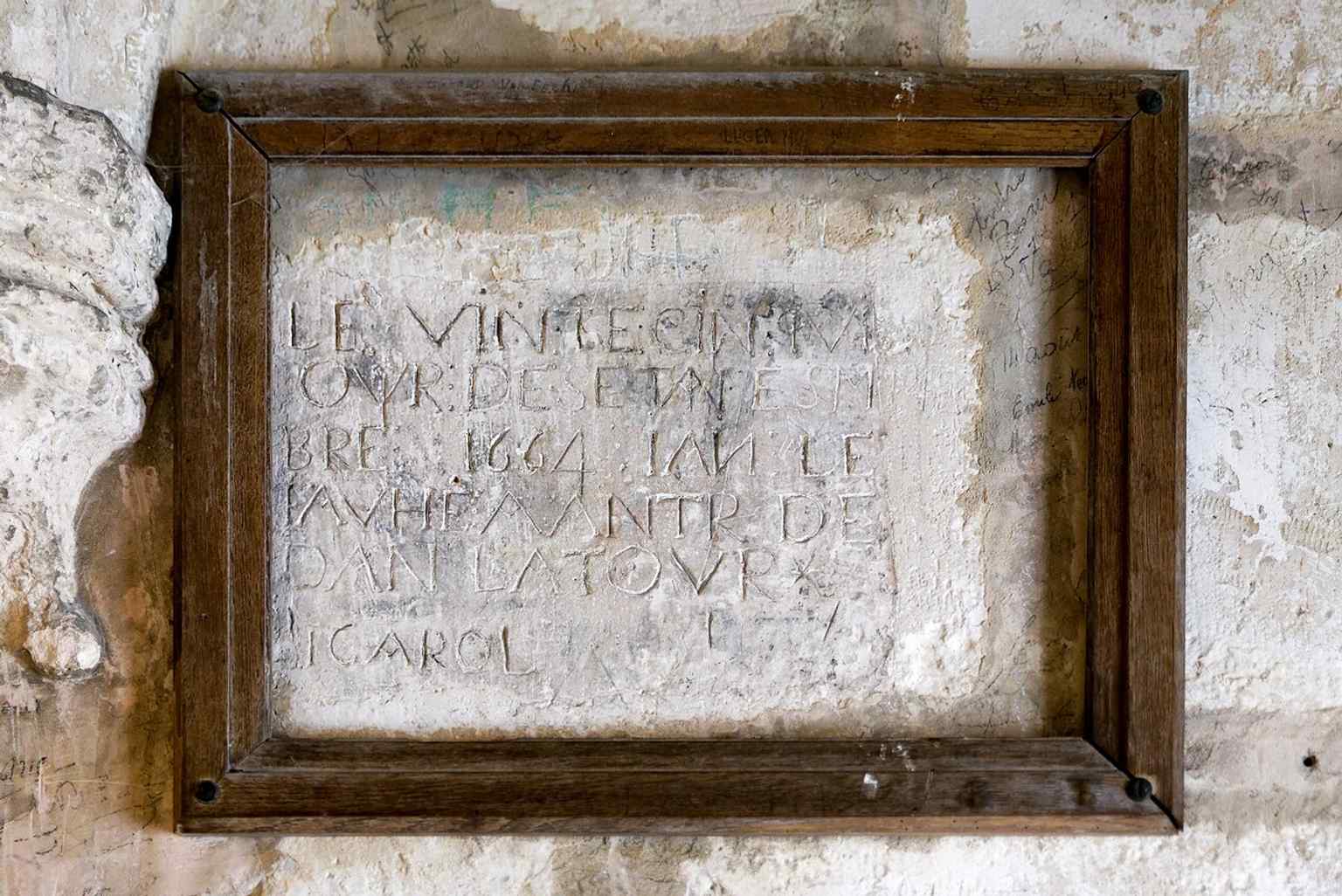 Traces of old graffiti on the tower walls — a small but vivid reminder that Saint Nicholas Tower was also used as a prison.
