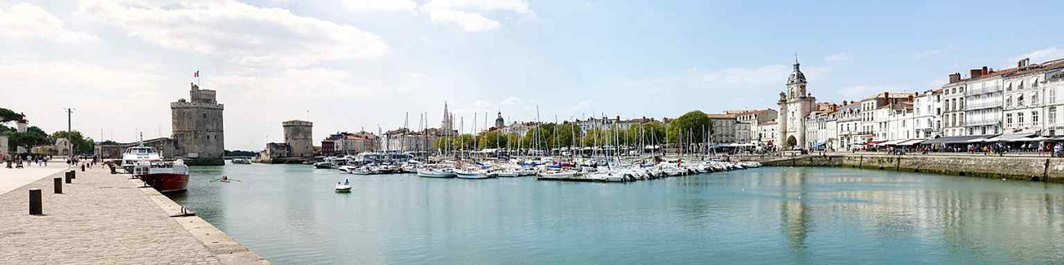 A sweeping port view with Saint Nicholas Tower, the Chain Tower, and the Old Port — ideal for explaining how the towers guarded the harbor entrance.