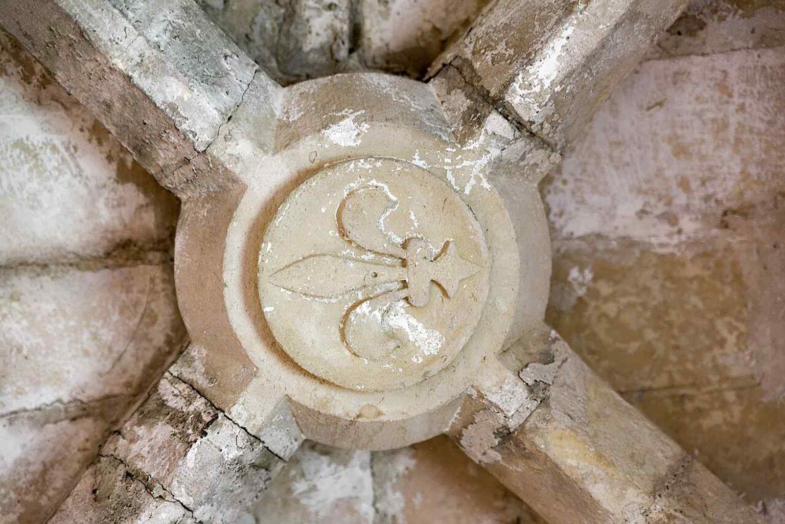 A vault keystone inside Saint Nicholas Tower, one of the Gothic interior details that survive in its layered medieval spaces.