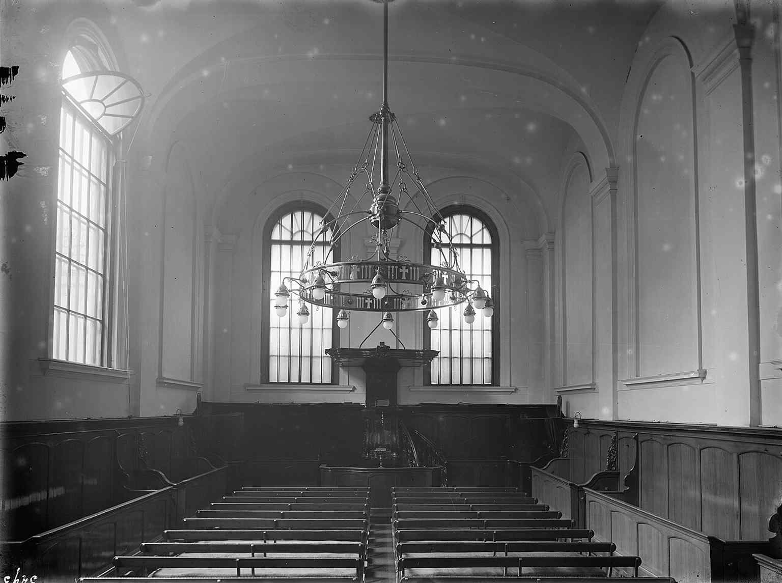 A general interior view of the small hall church from 1921, showcasing its simple yet strict Louis XVI style and the pulpit.