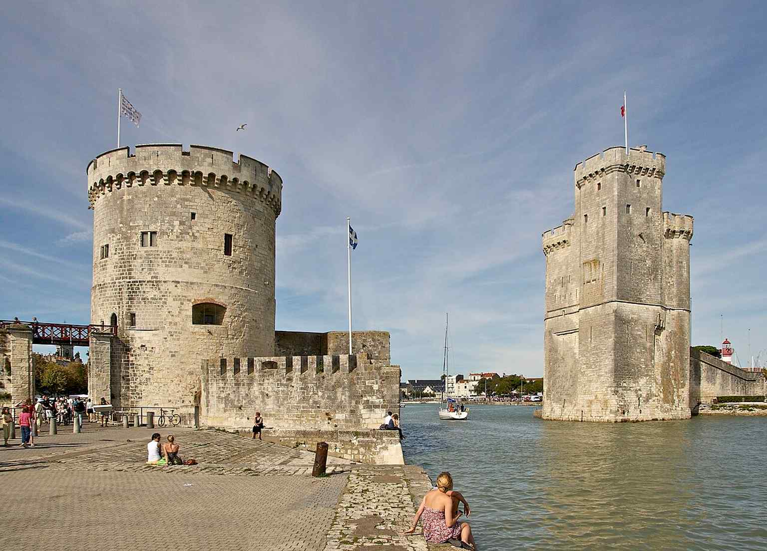The entrance to the old harbor in one frame, useful for showing how the Chain Tower sits at the seaward gate of La Rochelle.