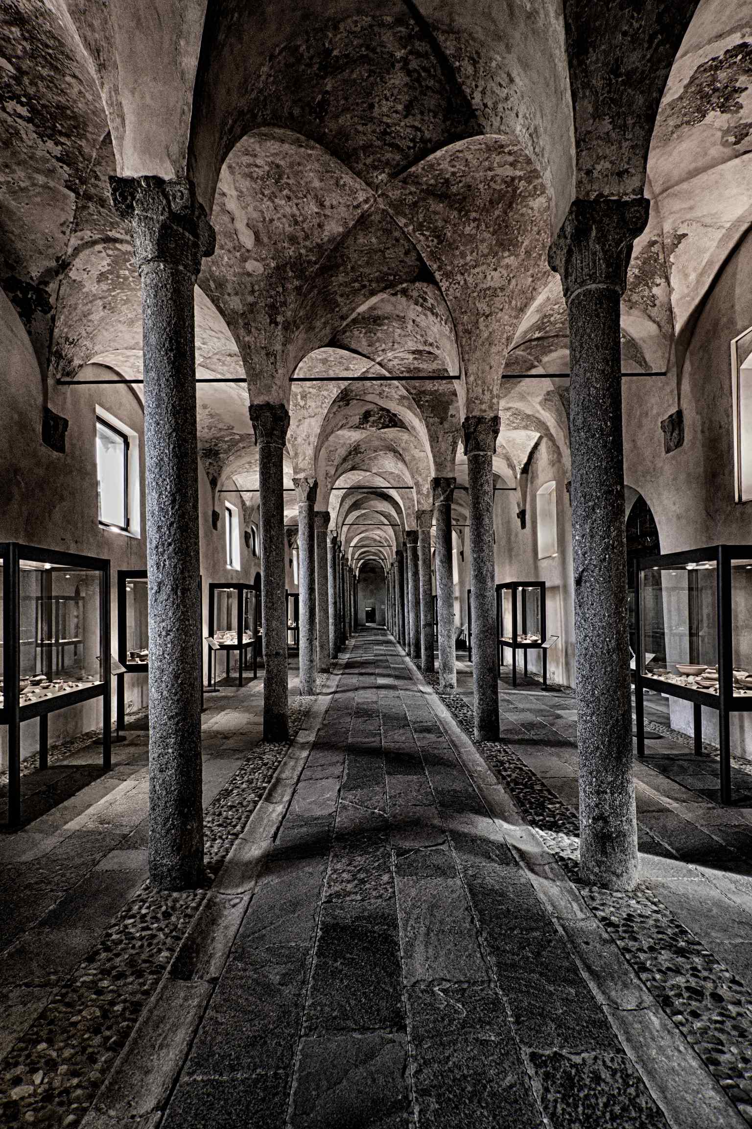 A view of a colonnade within the National Archaeological Museum of Lomellina, which has undergone significant modernization and expansion, including the opening of a new hall in 2018.