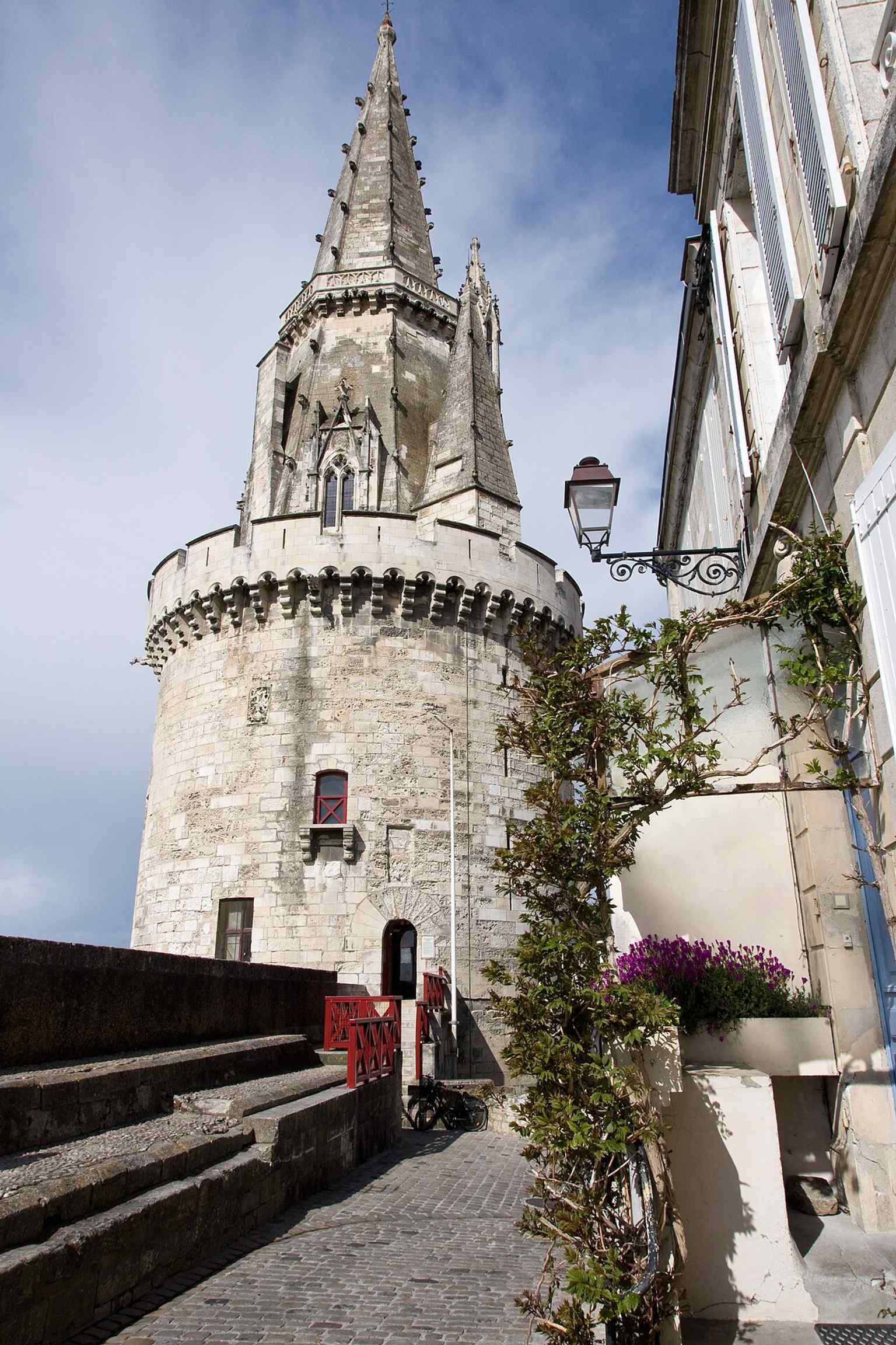A strong full-height view of the Lantern Tower, the 55-meter medieval sentinel that once guarded the old port of La Rochelle.