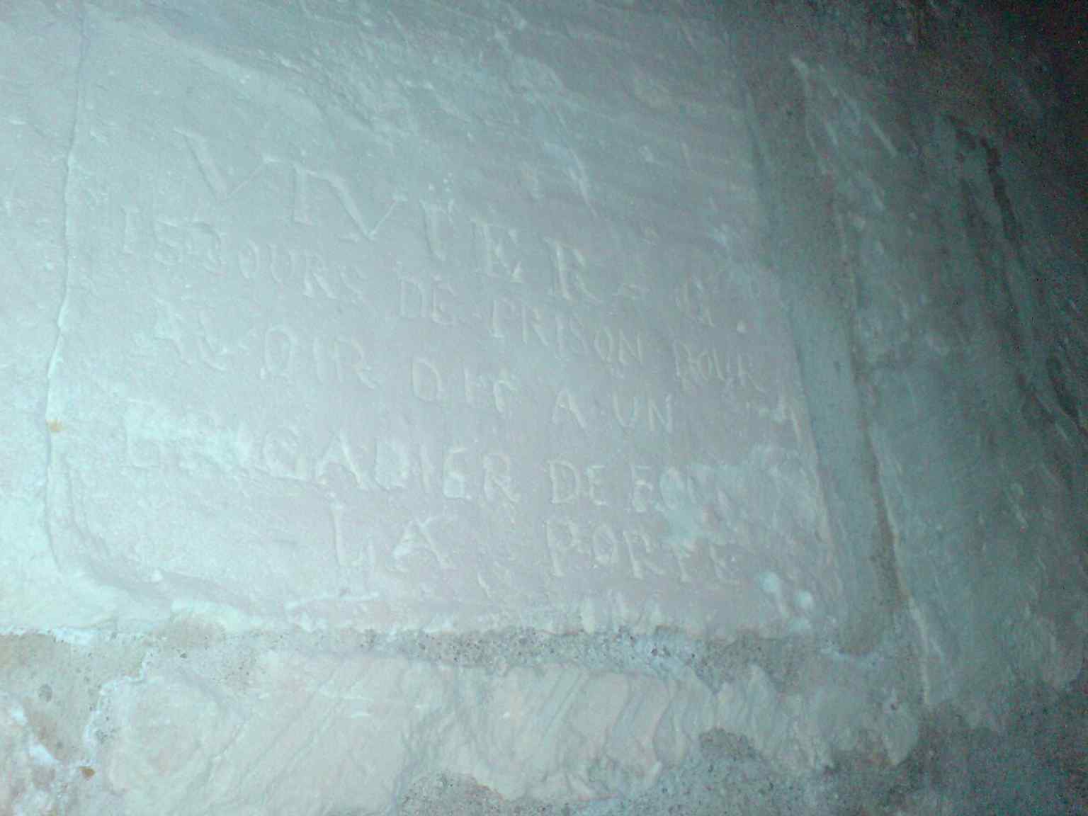 A prison graffito carved by a captive sailor, one of more than 600 inscriptions left inside the tower over centuries of confinement.