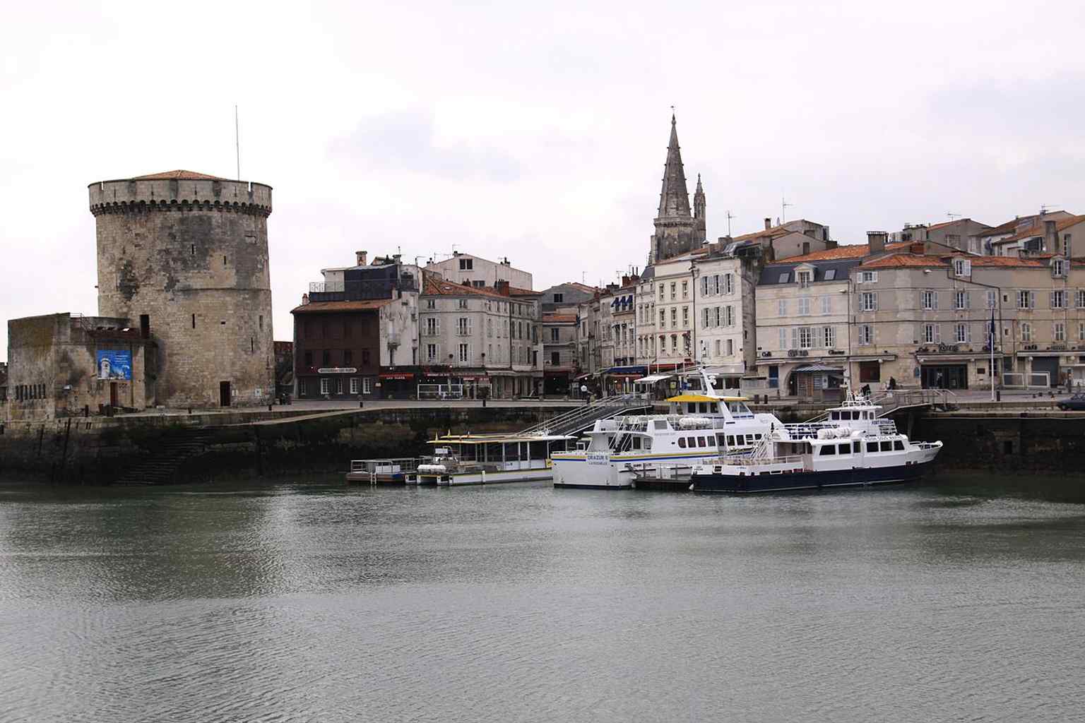 The Lantern Tower visible across the basin, showing its relationship to the harbor and the neighboring Chain Tower.