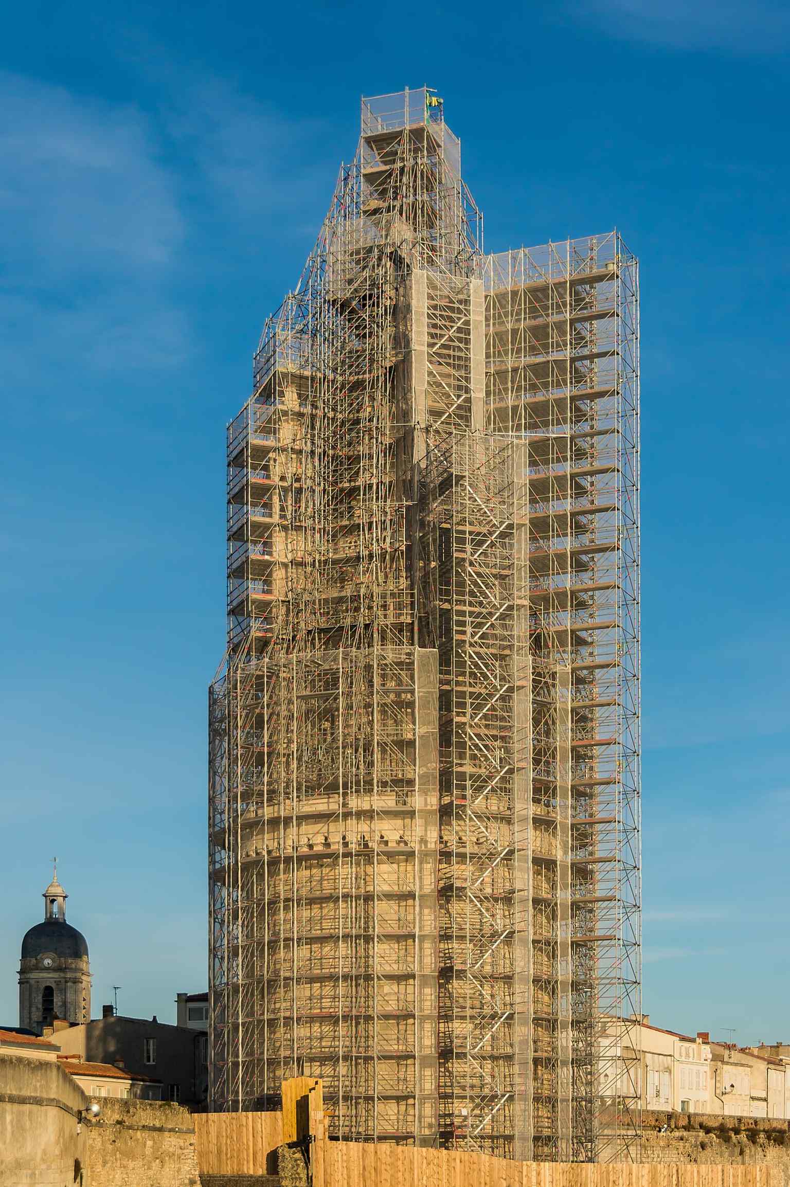 The tower under scaffolding during restoration in 2015, echoing the major conservation work that preserved its medieval profile.
