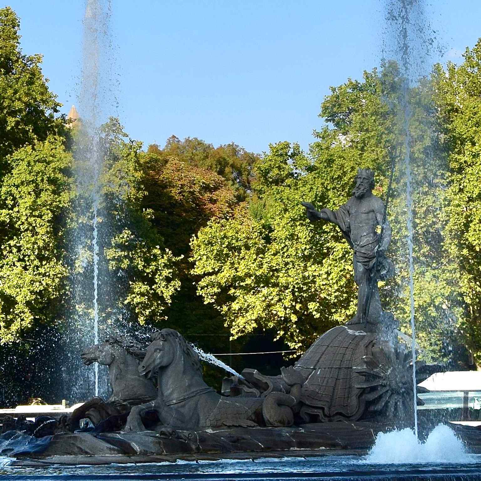 A posed modern photo that clearly shows Neptune riding the sea-chariot, matching the mythological imagery described in the source text.