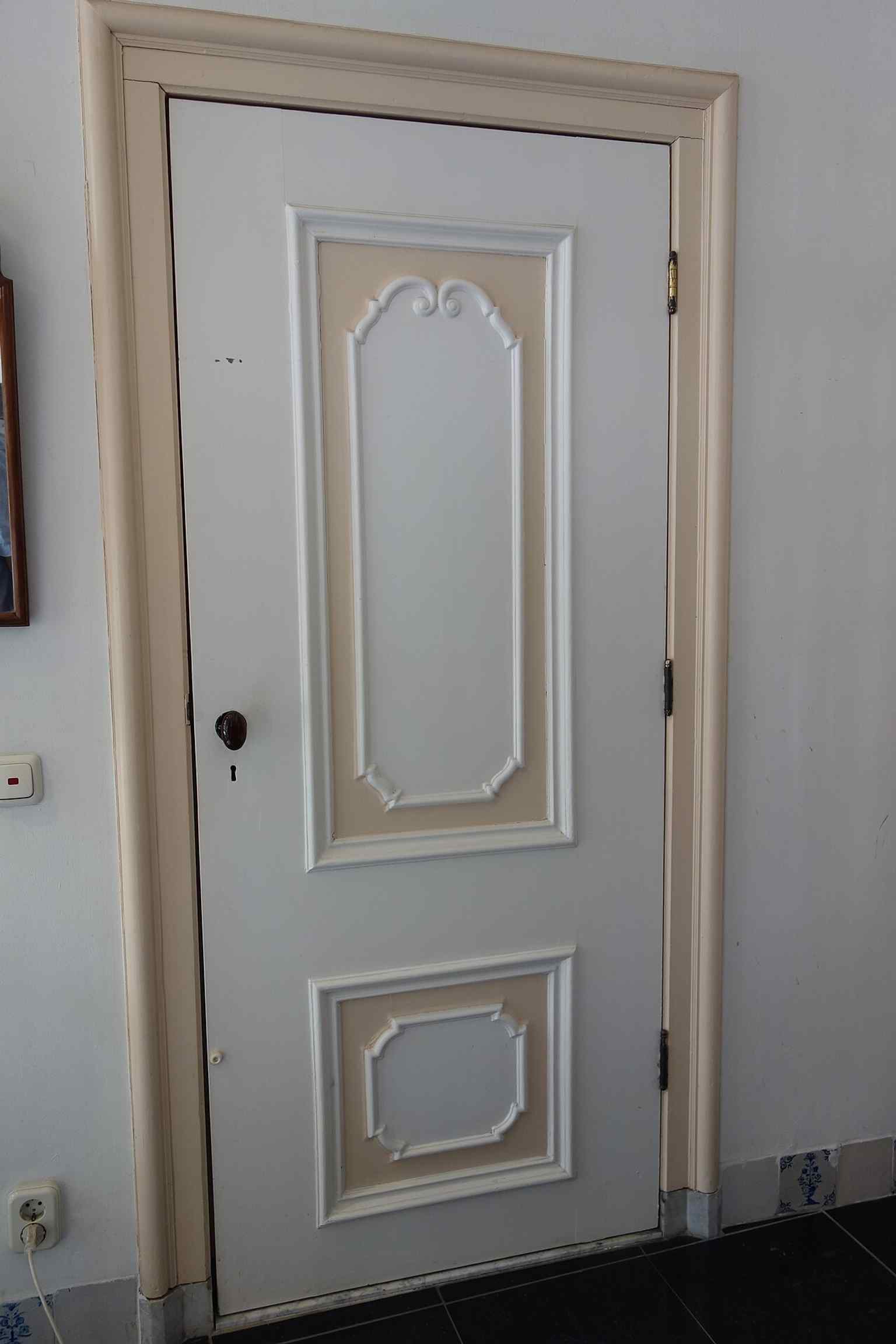 A painted interior door shows the preserved domestic side of the building, once home to families such as the Van Zurens.